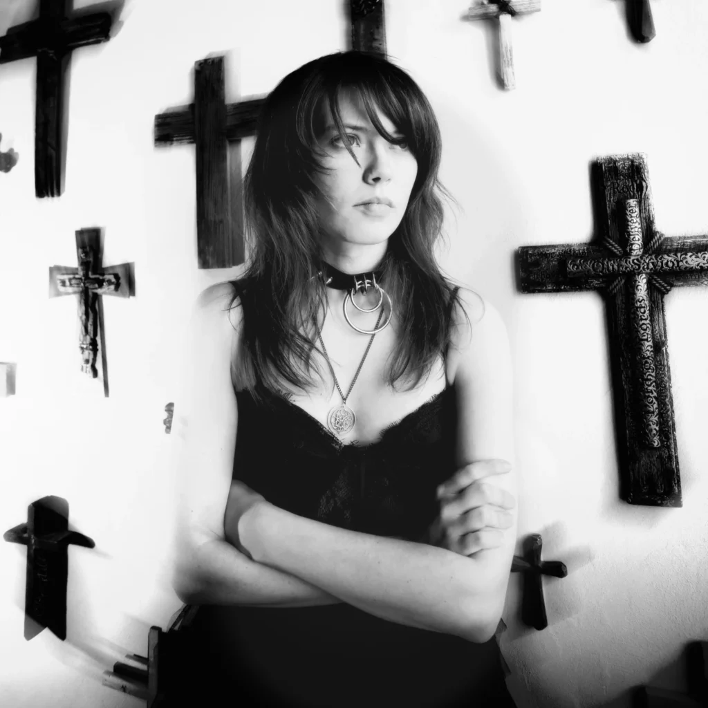 Woman with crosses in background Staytus