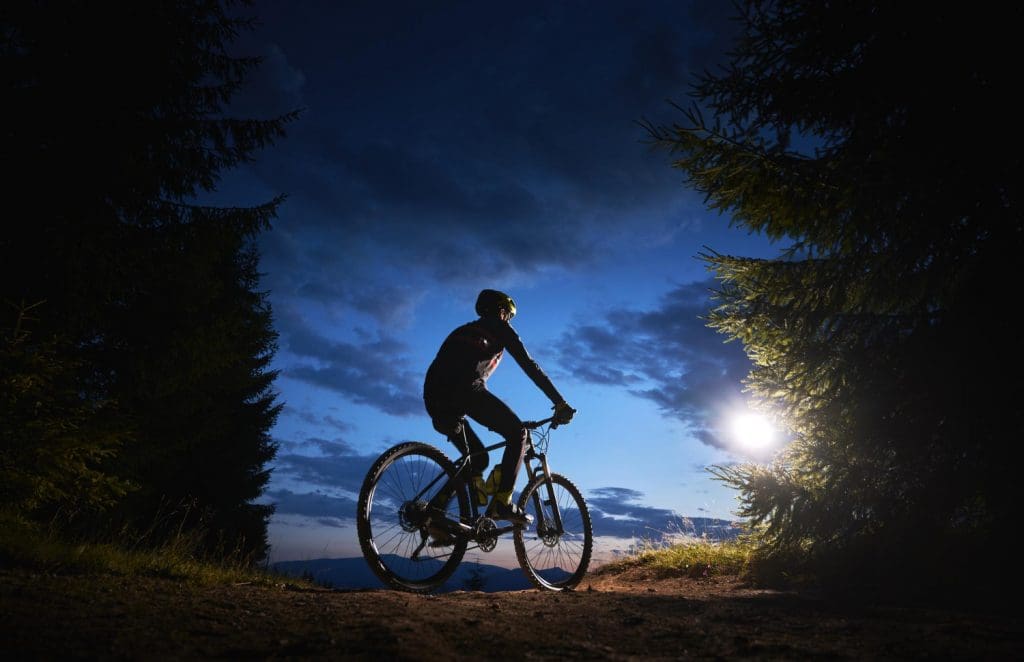 Male-cyclist-sitting-bicycle-beautiful-night-sky