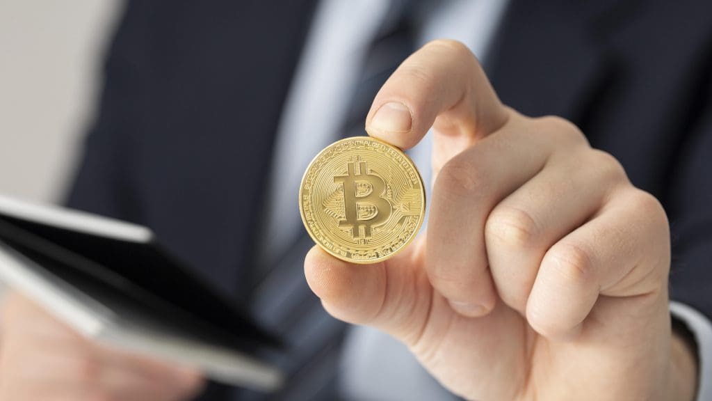 Businessman-holding-bitcoin-close-up