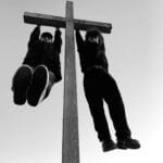 Two figures hanging from a cross.